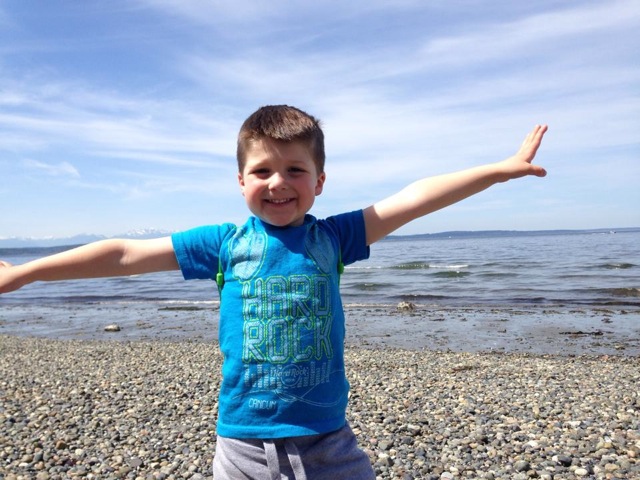 Boy on Alki beach open arms