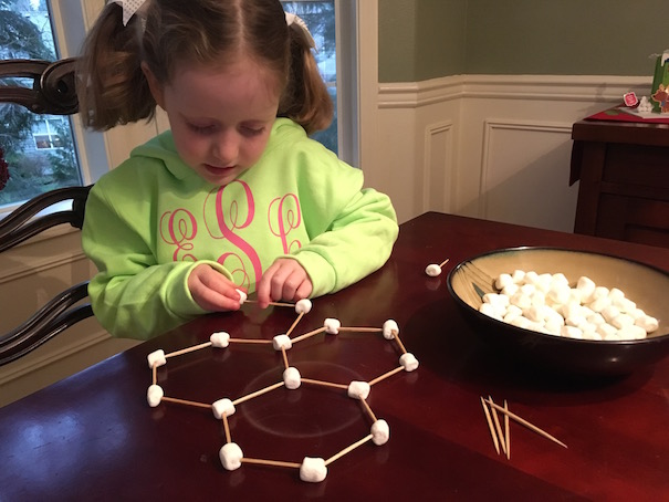girl learning about snowflake science