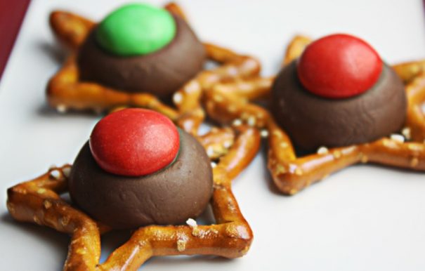 Chocolate kisses are melted on top of pretzels and topped with M&Ms