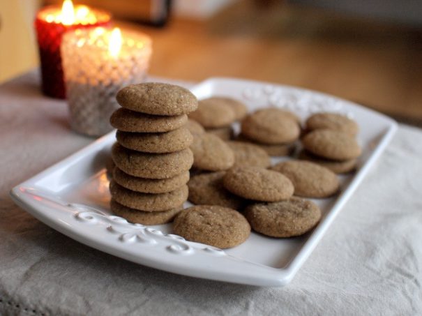 A white tray filled with little round soft ginger cookies