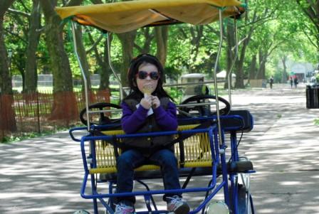 Kid eating ice cream on quad bike