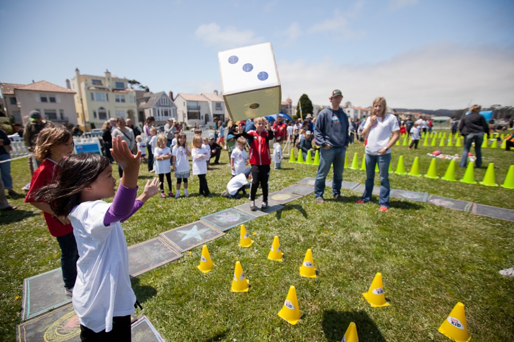 Attendees rolling the dice in Sidewalk Chalk Adventure