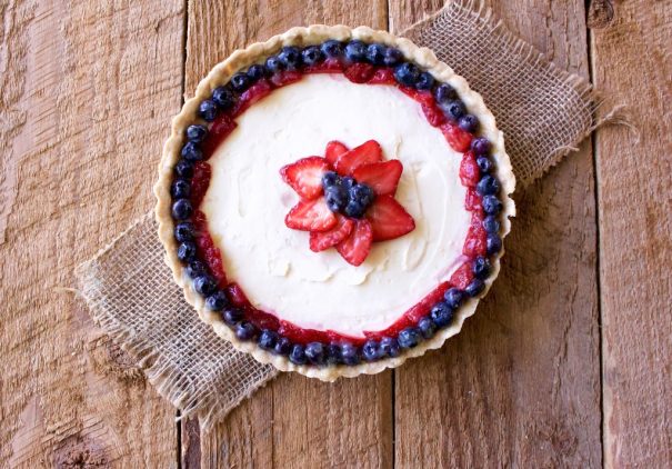 Vanilla cream fruit tart decorated with strawberry and blueberry for Memorial Day