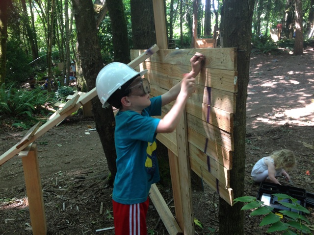 Boy hammering board Adventure Playground