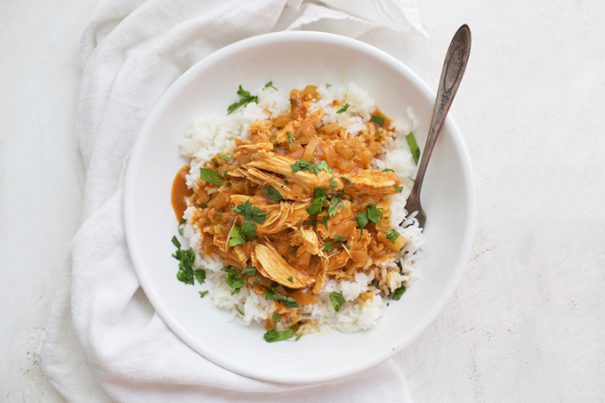 A bowl filled with dinner made from a chicken tikka masala crock pot recipe