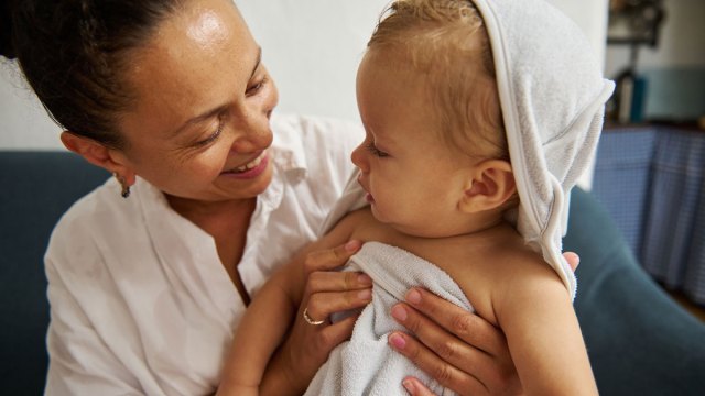 mom and toddler after a bath using household items that can be used as toys