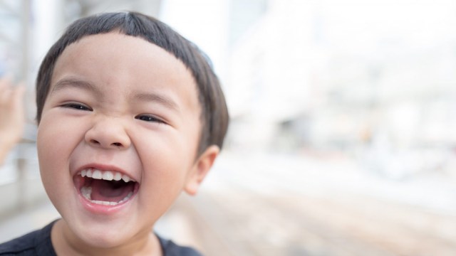 kid laughing at cheesy jokes