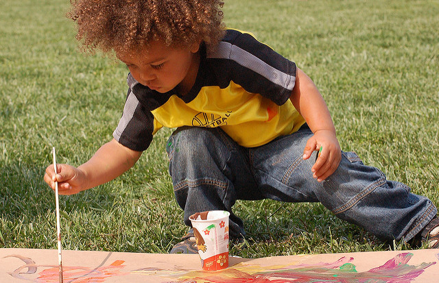 Kid painting on grass