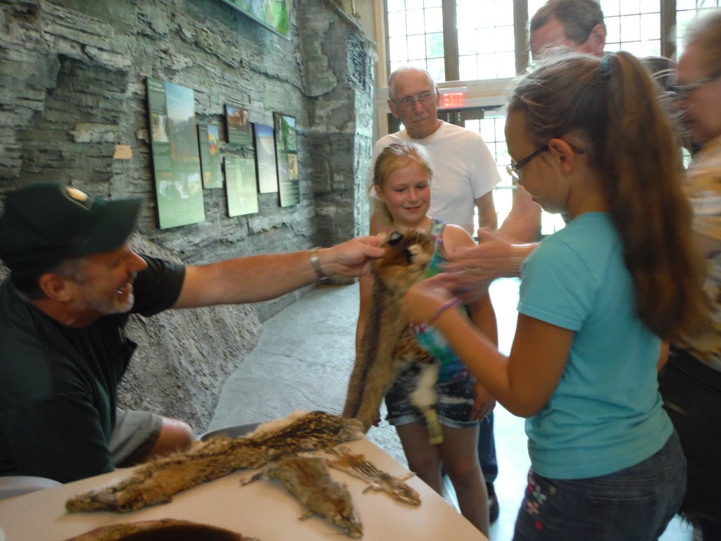 Humphrey Nature Center at Letchworth State Park. Children learning about animal pelts. 