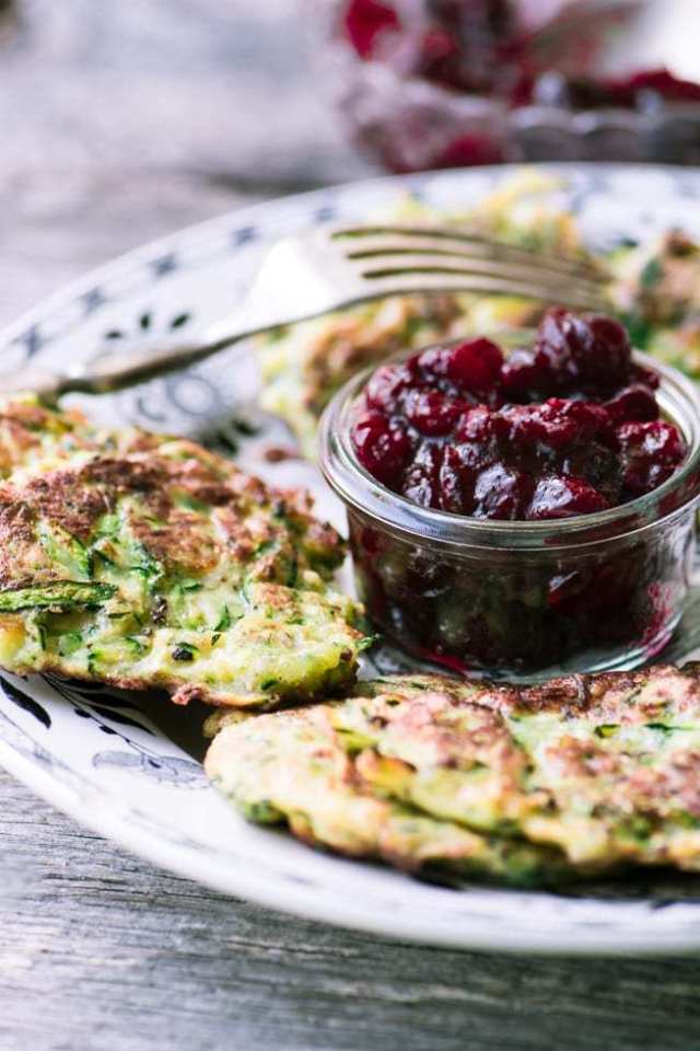 Easy to make maple cranberry sauce surrounded by Zucchini Latkes