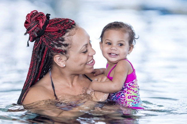 a mom and baby in a swimming pool, places to have fun