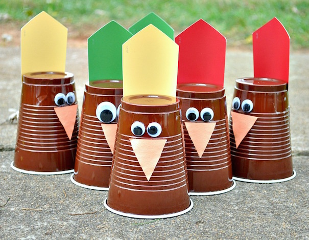 Brown cups are made to look like turkeys for a Thanksgiving turkey bowling game
