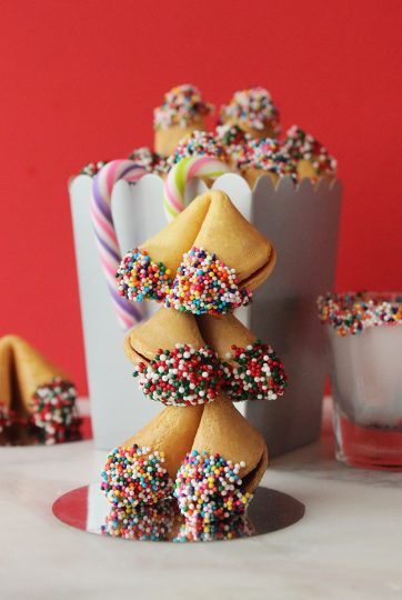 A stack of chocolate-dipped, colorfully sprinkled fortune cookies