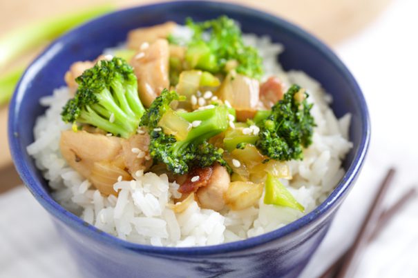 A blue bowl filled with rice topped with Honey Garlic Chicken & Broccoli Stir-Fry