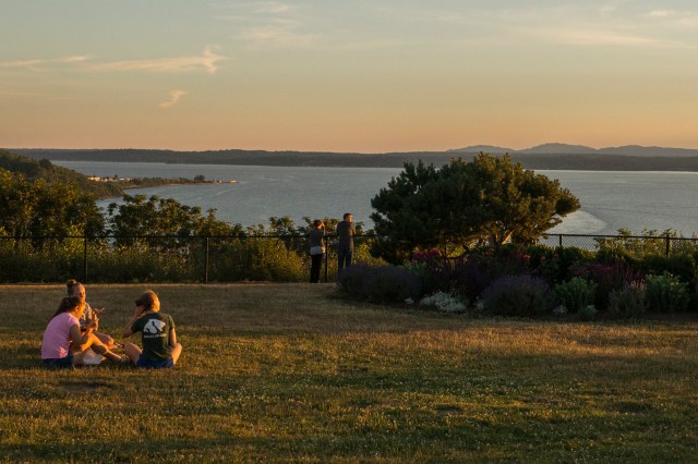A family enjoying a summer picnic spot in Seattle at sunset