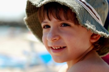 child with sunblock and hat