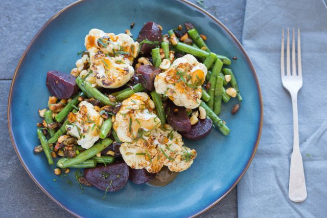 Cauliflower, green beans and beets sit prepared on a plate from Purple Carrot meal delivery service