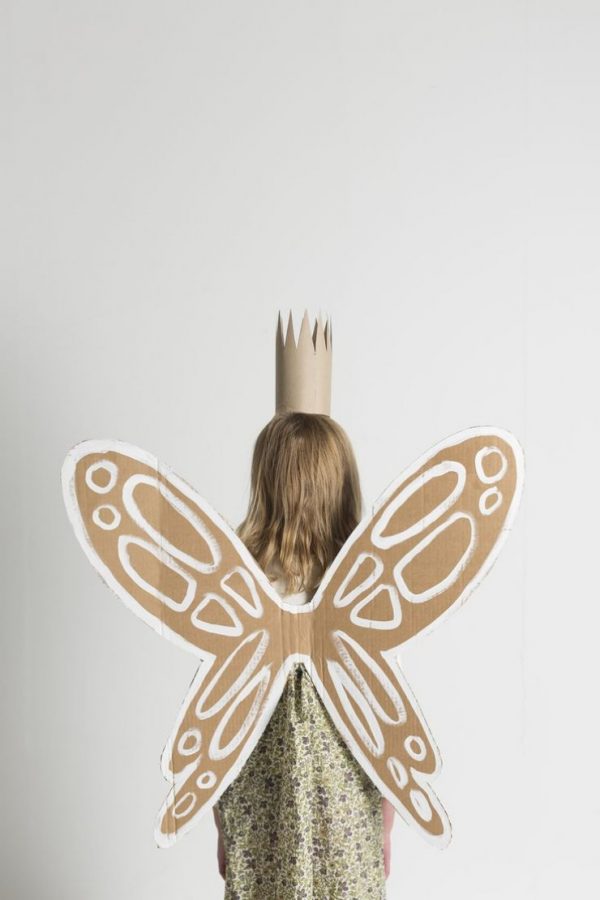 Fairy wings made from a cardboard box are worn by a little girl for Halloween