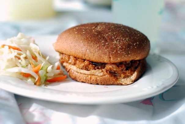 Sloppy Joes made from a crock pot are served in a bun on a plate
