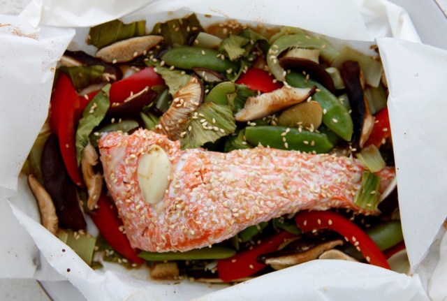 Fish in parchment paper is cooked as a sheet pan dinner