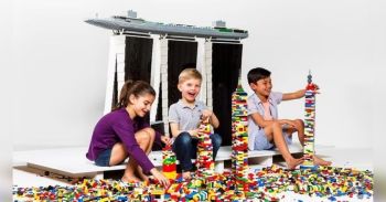 three children playing with legos at best childrens museum