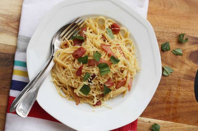 Pasta carbonara with no cream sits on a white place waiting to delight picky eaters