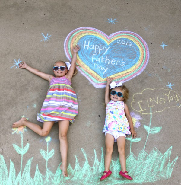 two girls surrounded by a happy father's day chalk drawing card