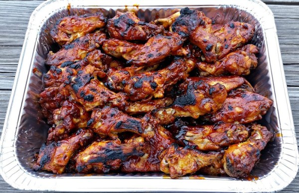 A platter filled with chicken wings that were cooked in a crock pot