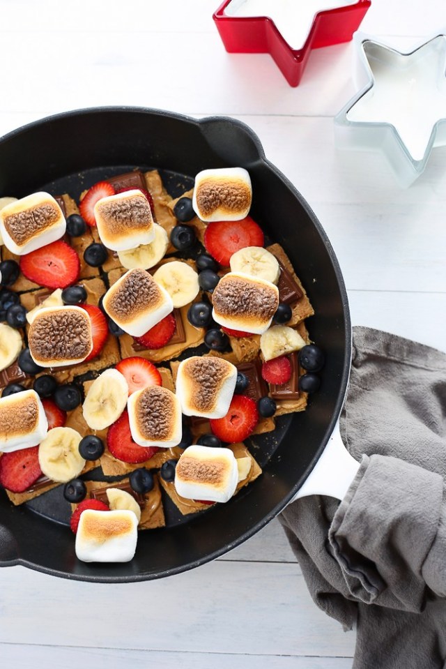A skillet with toasted marshmallows, strawberries and blueberries for Memorial Day