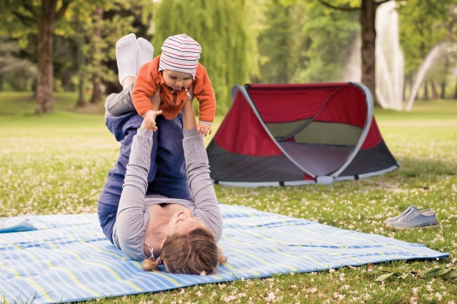 mom playing with baby at campsite with baby camping tent