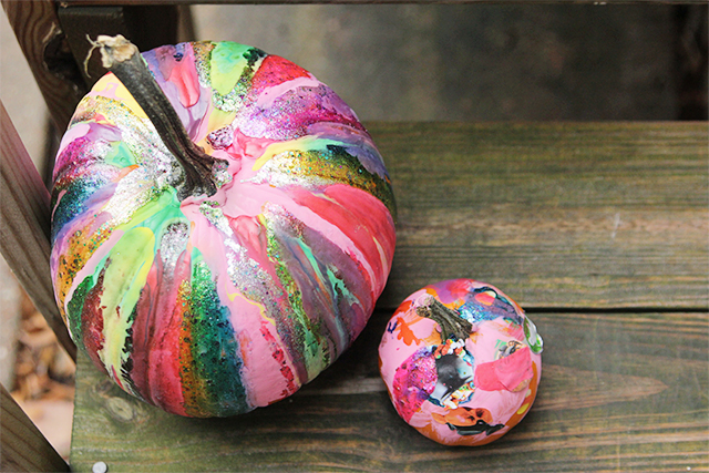 A pumpkin is colorfully decorated through dripping paint on it