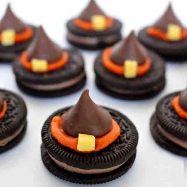 Decorated chocolate kisses sit on top of Oreos to create the Halloween treat Witch Hat Cookies