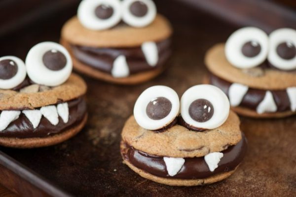 These Halloween treats are chocolate monster cookies with candy googly eyes, chewy chocolate chip cookies, and chocolate ganache.