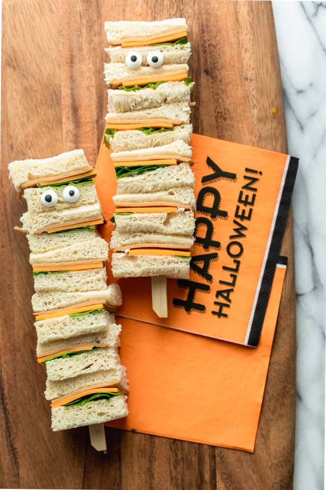 Two sandwich kebabs are stacked to look like tall monsters for a Halloween dinner