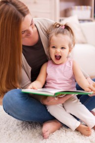 girl laughing with mom reading jokes for kids fun happy