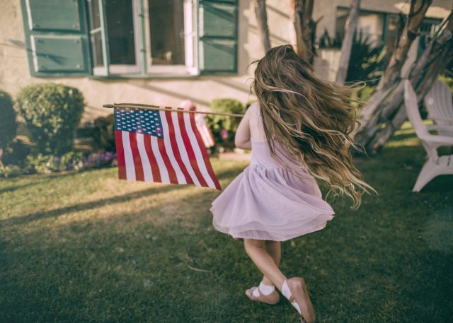 girl with american flag e1652803791271