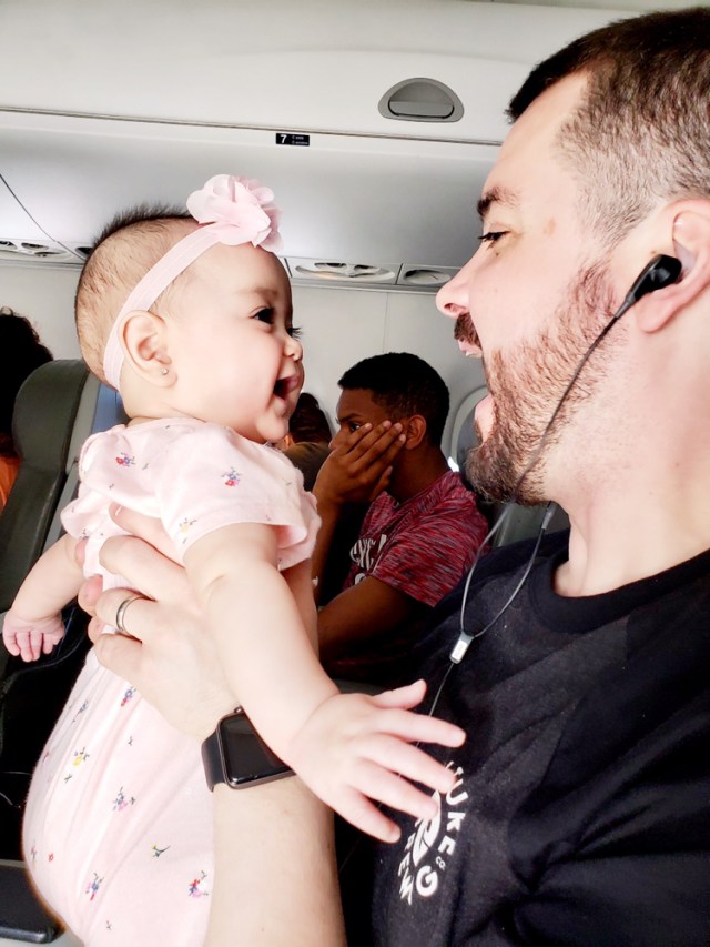 Dad holding baby, baby girl, airplane, flying, travel