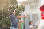 kids spraying hose, water