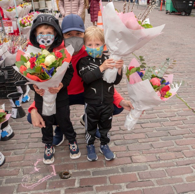 Kids shop for flowers at Pike Place Market as part of the Mom's Market Day activities