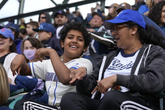 A mother and son watch the Mariners play on Mother's Day in Seattle