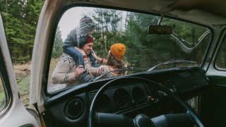 Family getting ready to walk outside of car on fall day