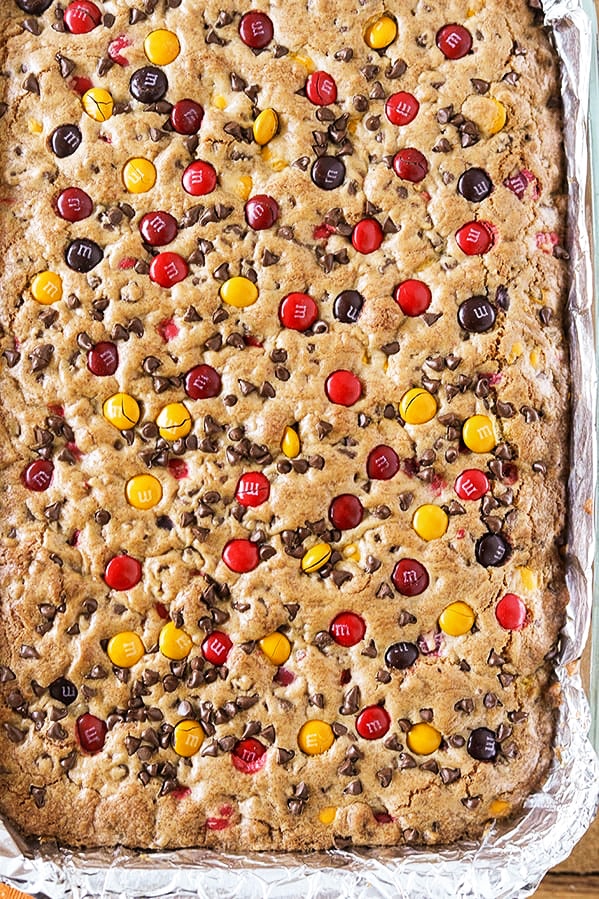 A tray of uncut Harvest M&M Cookie Bars ready to serve instead of pie at Thanksgiving dinner