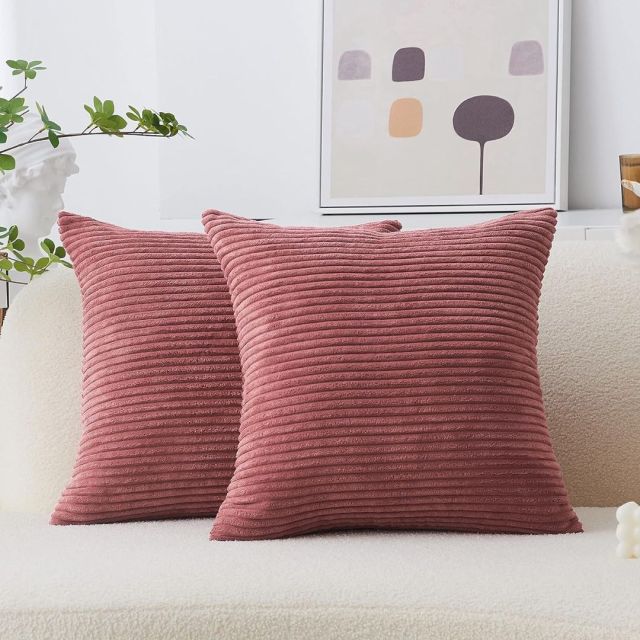 two mauve ribbed throw pillows on a cream couch