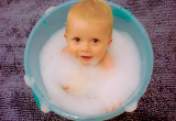 baby in bath with bubbles
