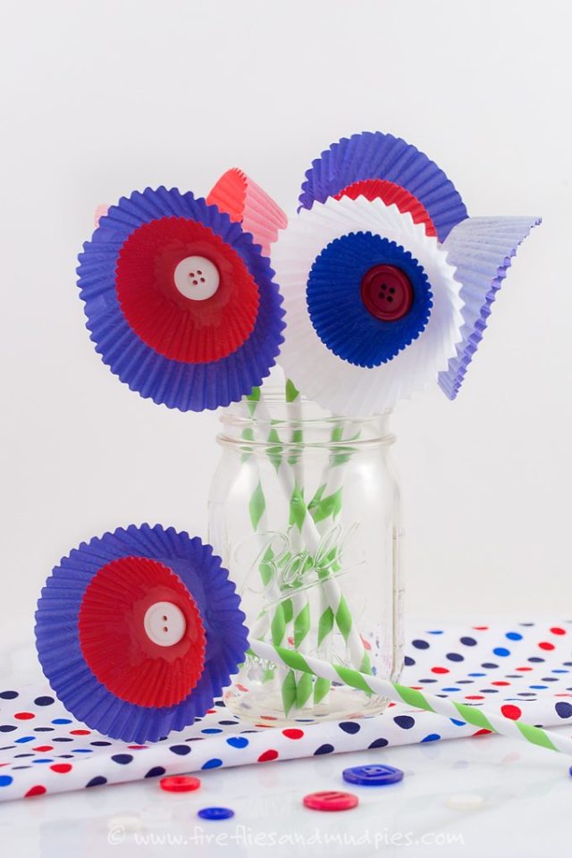 Cupcake liners connected to straws to become fourth of July craft flowers