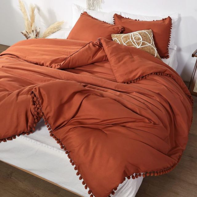burnt orange comforter on bed