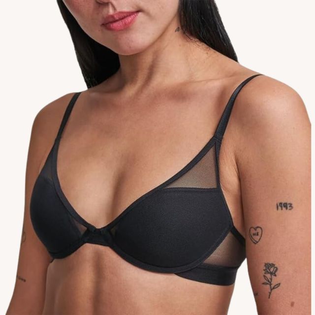 petite woman wearing black bra