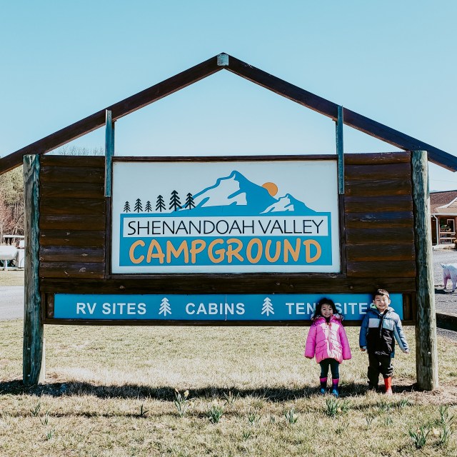 two children standing in front of Shenandoah Valley Campground sign