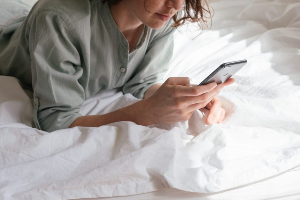 teen smartphone in bed