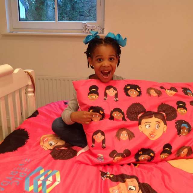 African-American Girl on Colorful Bed